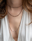 layered brown diamond necklaces on model