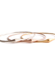 set of three in sterling silver, 14k yellow gold and 14k rose gold swell bangle
