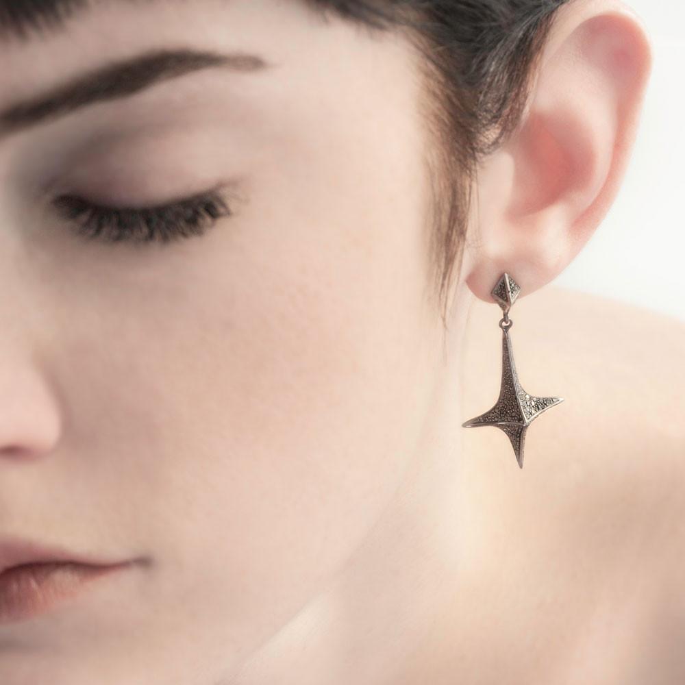 lis dangle earrings on model