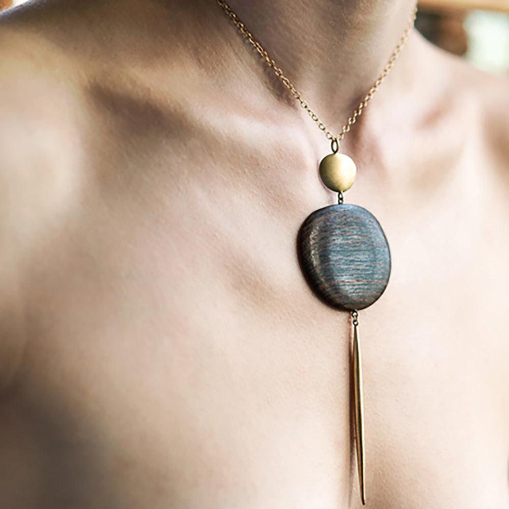 wood and bronze totem pendant on model
