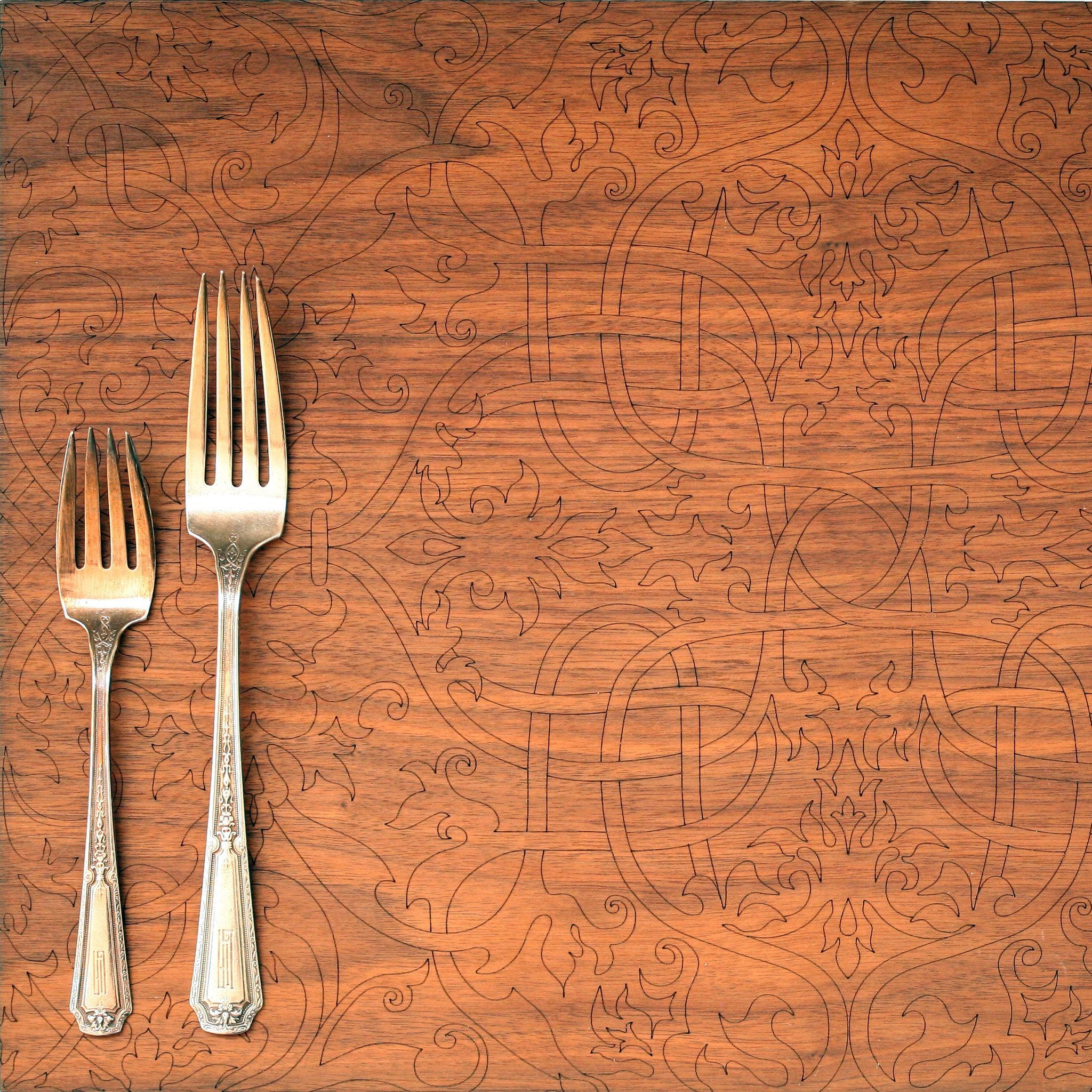 detail of laser etched walnut arabesque placemat