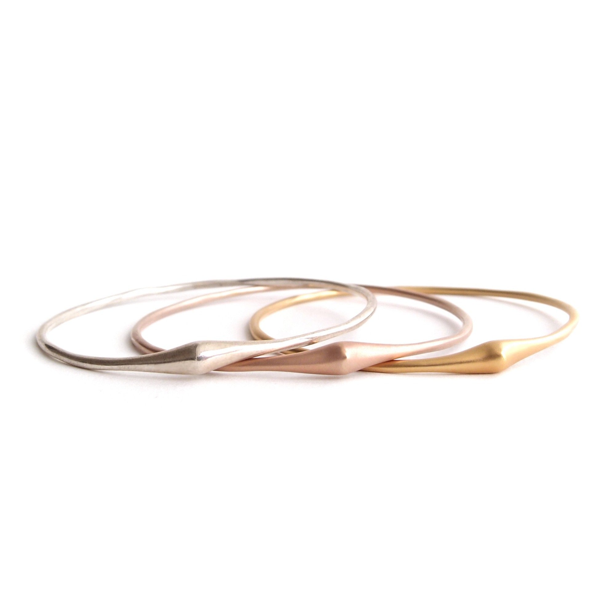 set of three in sterling silver, 14k yellow gold and 14k rose gold swell bangle